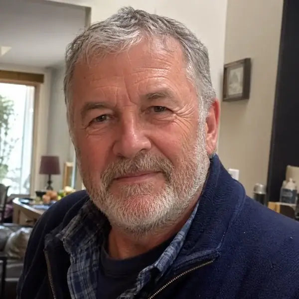 David John, 66, smiling at home